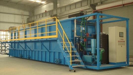 Effluent treatment plant with blue process tanks and pipework